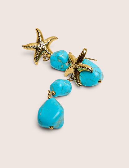 Estrella de mar con detalle y gota de piedra azul en dorado